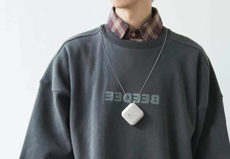 Mini USB rechargeable air purifier necklace in blue, shown with charging cable.
