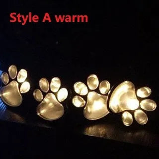 Black solar powered animal paw print garden lights with four paw shapes connected to solar panel
