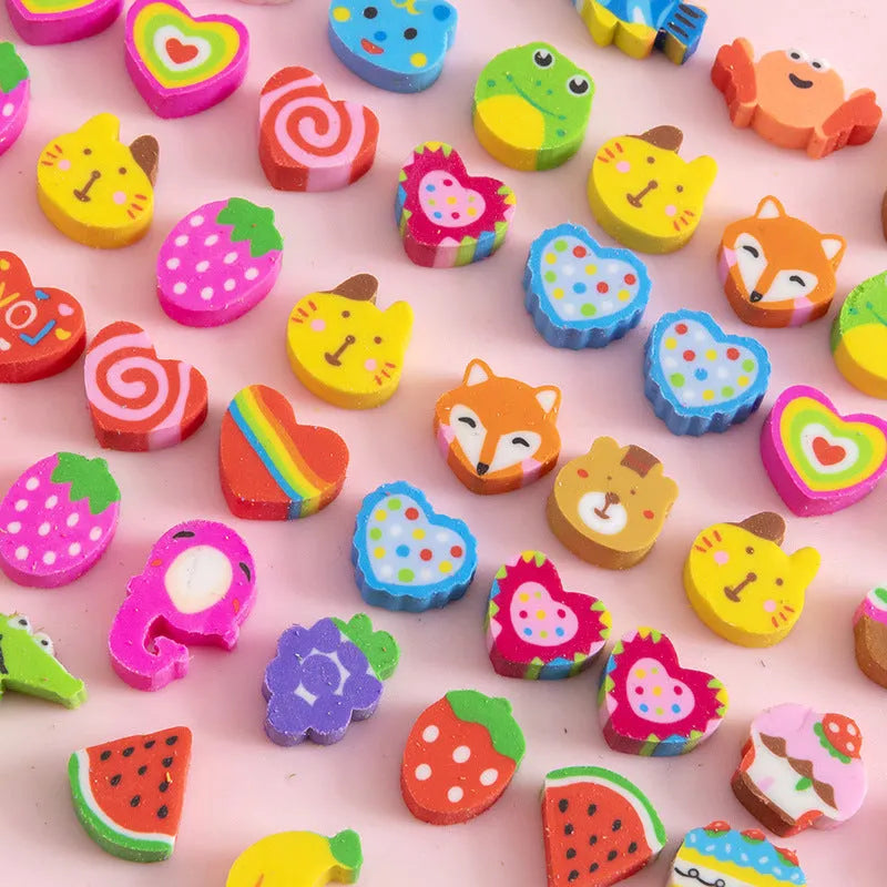 Assortment of 50 colourful mini cartoon erasers in shapes of fruits, animals, and cakes on a white background.
