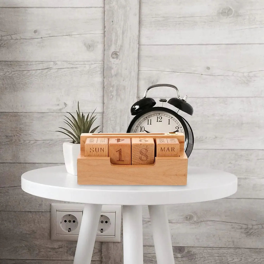 Solid wood simple modern calendar desk sign in natural wood colour on a desk.