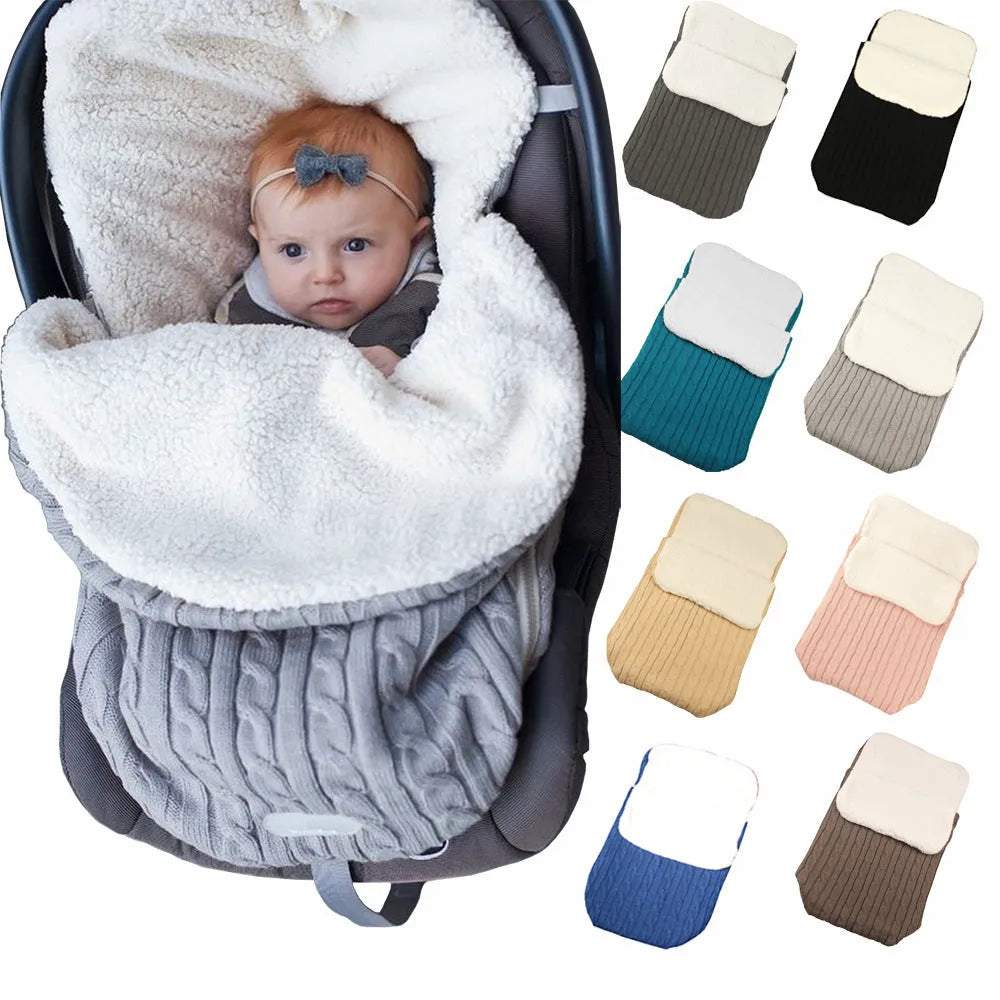 Envelope-style baby stroller sleeping bag in beige colour with thick filling, shown next to a pram.