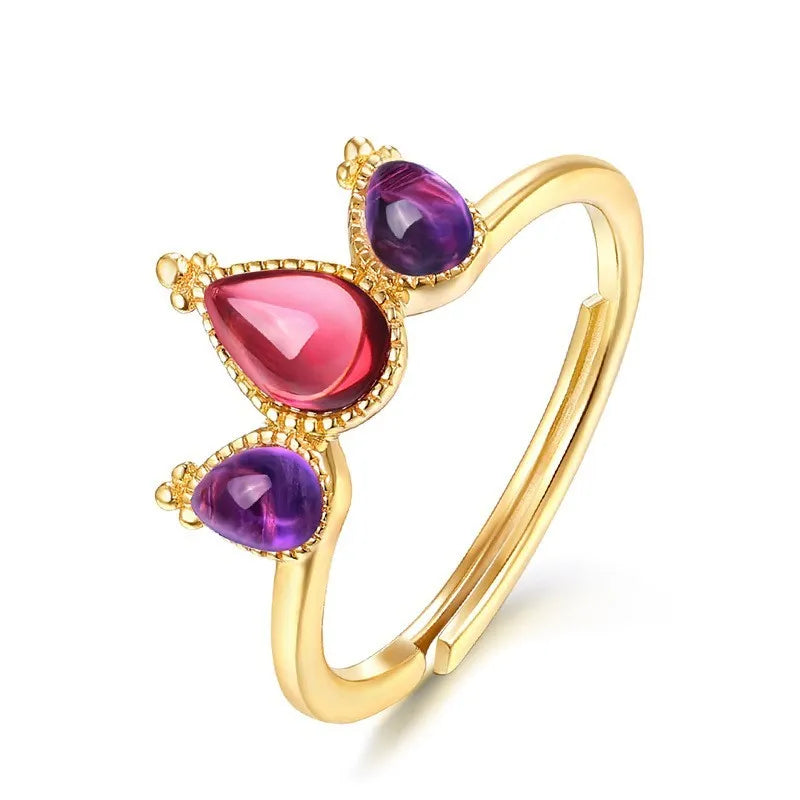 Sterling silver ring with drop-shaped garnet stone on finger, 925 silver, electroplated finish