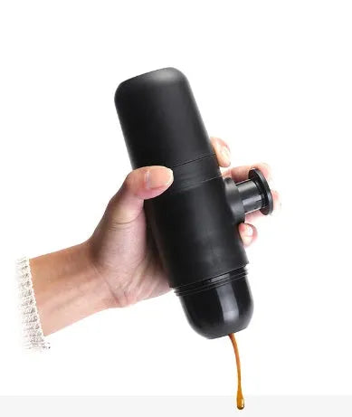 Compact black portable manual coffee machine for espresso, shown with dimensions 6cm by 17.5cm