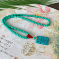 Hand-woven turquoise necklace with a large mesh flower lucky pendant on an adjustable ball bead chain.