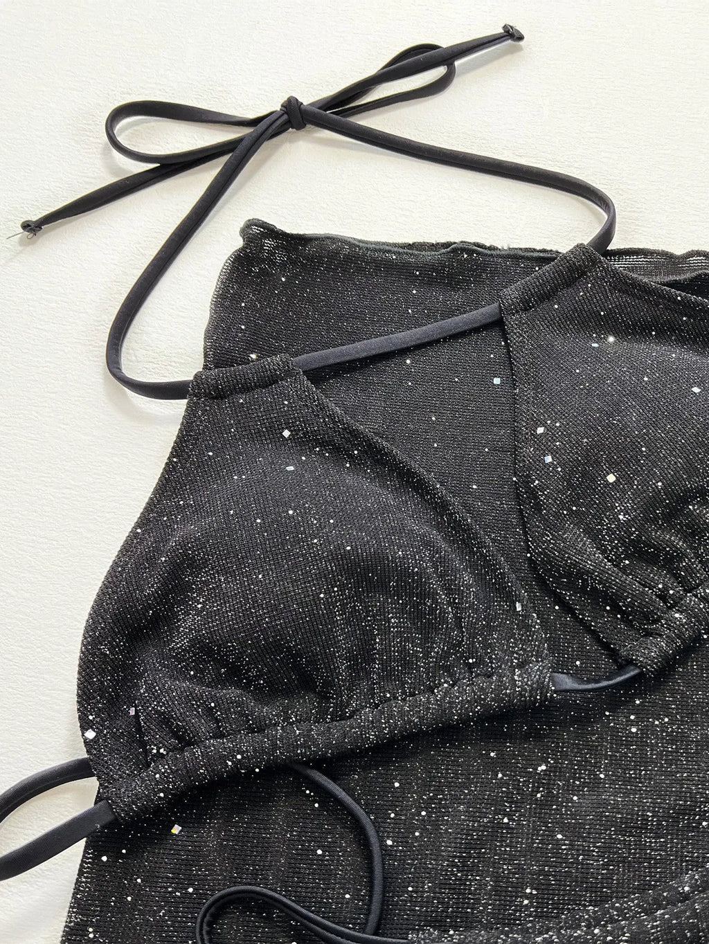 Black polyester fibre bikini set comprising a top and matching shorts on a mannequin.