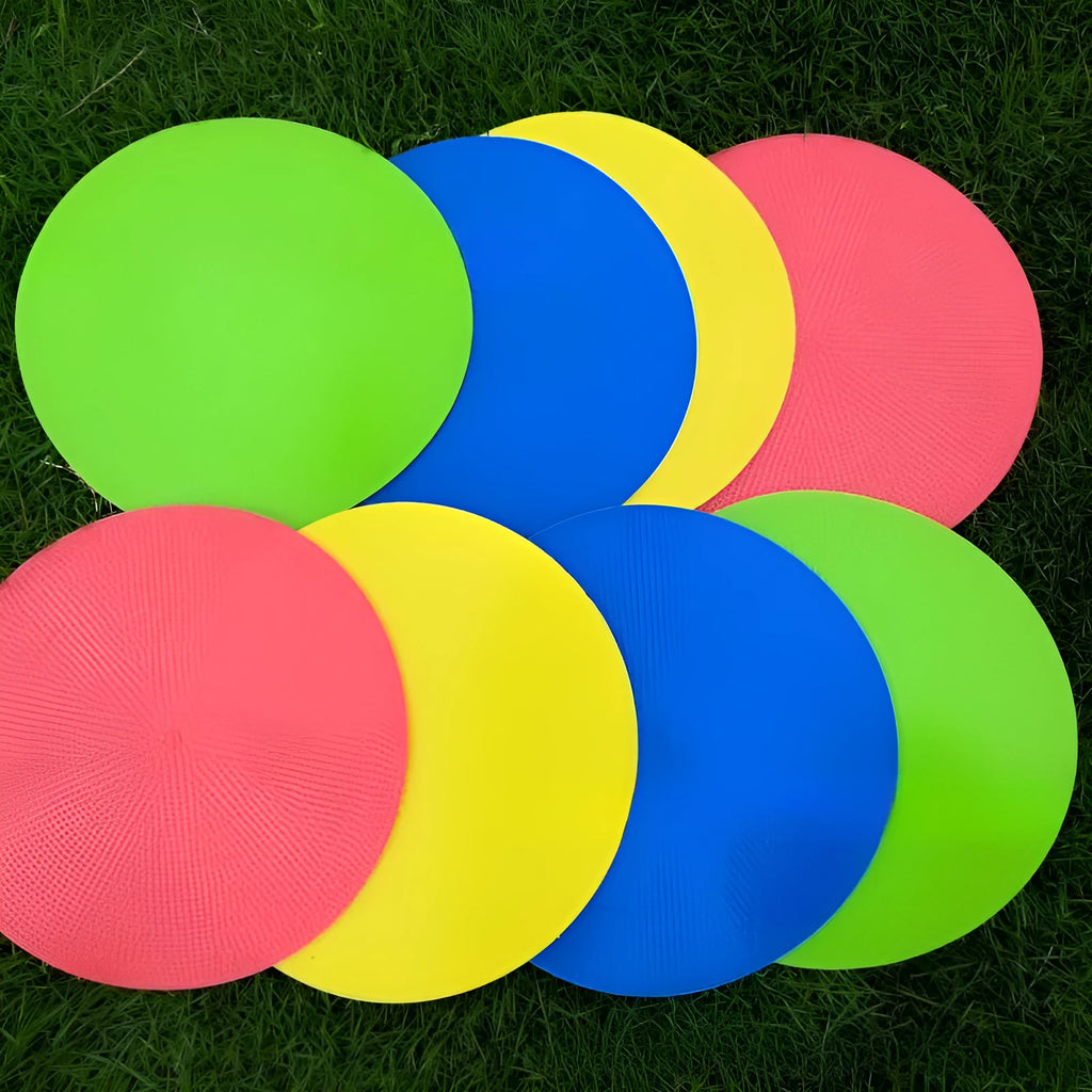 Yellow TPE football training landmark pad, 23cm diameter flat disc on grass.