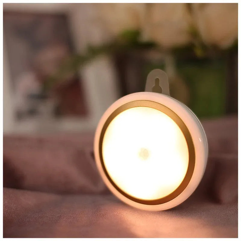 Compact round white motion sensor LED light for automatic wardrobe and corridor lighting.