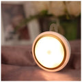Compact round white motion sensor LED light for automatic wardrobe and corridor lighting.