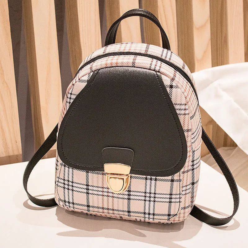 A one shoulder diagonal phone bag made from black PU fabric, shown being worn crossbody.
