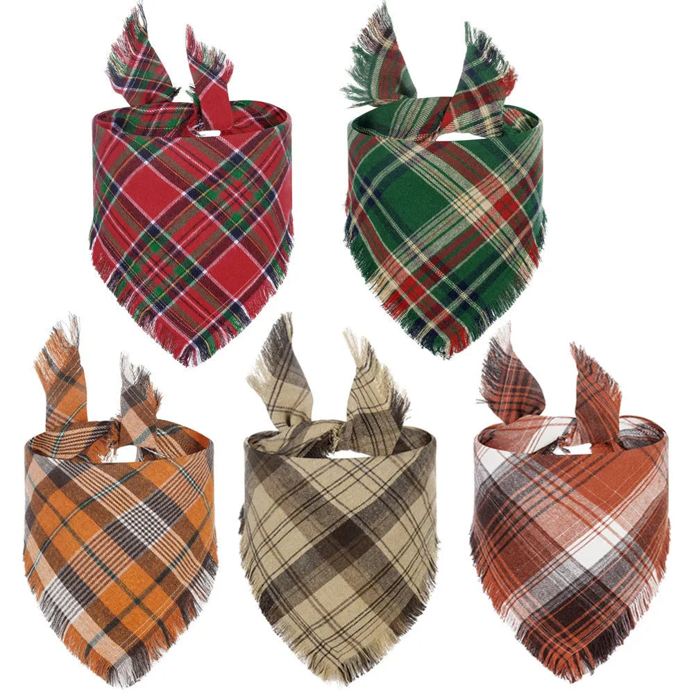 Plaid triangle dog bandana with tassel edges in autumn colours like brown, green, and orange.