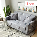 Geometric pattern stretch sofa slipcover and matching cushion cover on a double seat sofa.
