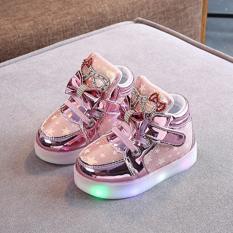 LED magic button sneakers in golden, pink, and silvery metallic finishes with illuminated soles