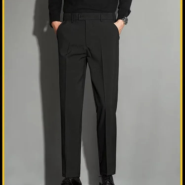 Men's straight-leg ankle-length suit trousers in a light colour showing spring draping effect detail.