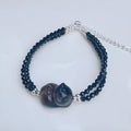 Natural obsidian bracelet with a hand-carved climbing cat charm in Korean style.