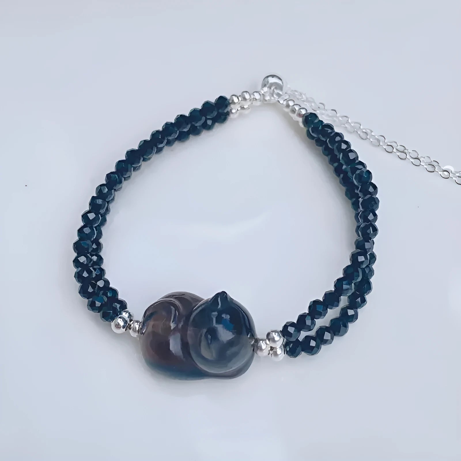 Natural obsidian bracelet with a hand-carved climbing cat charm in Korean style.