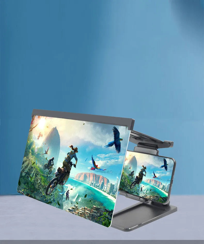 Black detachable mobile phone screen magnifier and holder set up on a desk, showing a phone displaying a magnified movie scene.