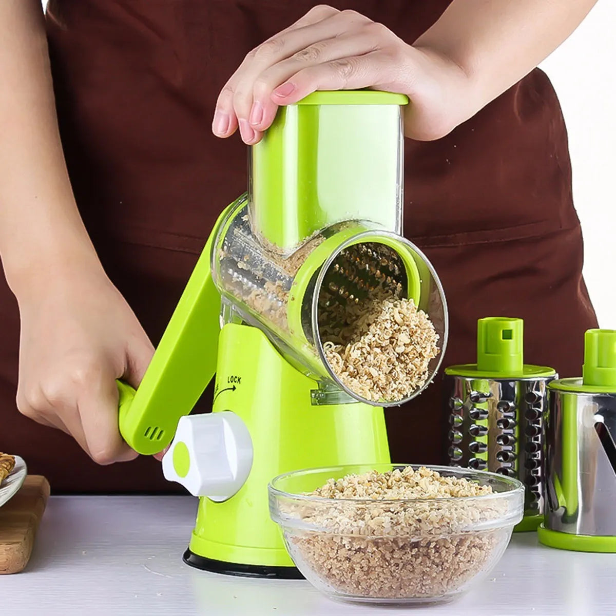 Blue green mandoline vegetable slicer with suction cup base and three stainless steel blades.