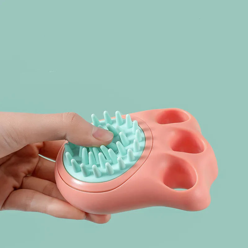Blue silicone claw-shaped pet bath brush with flexible bristles for washing cats and dogs.