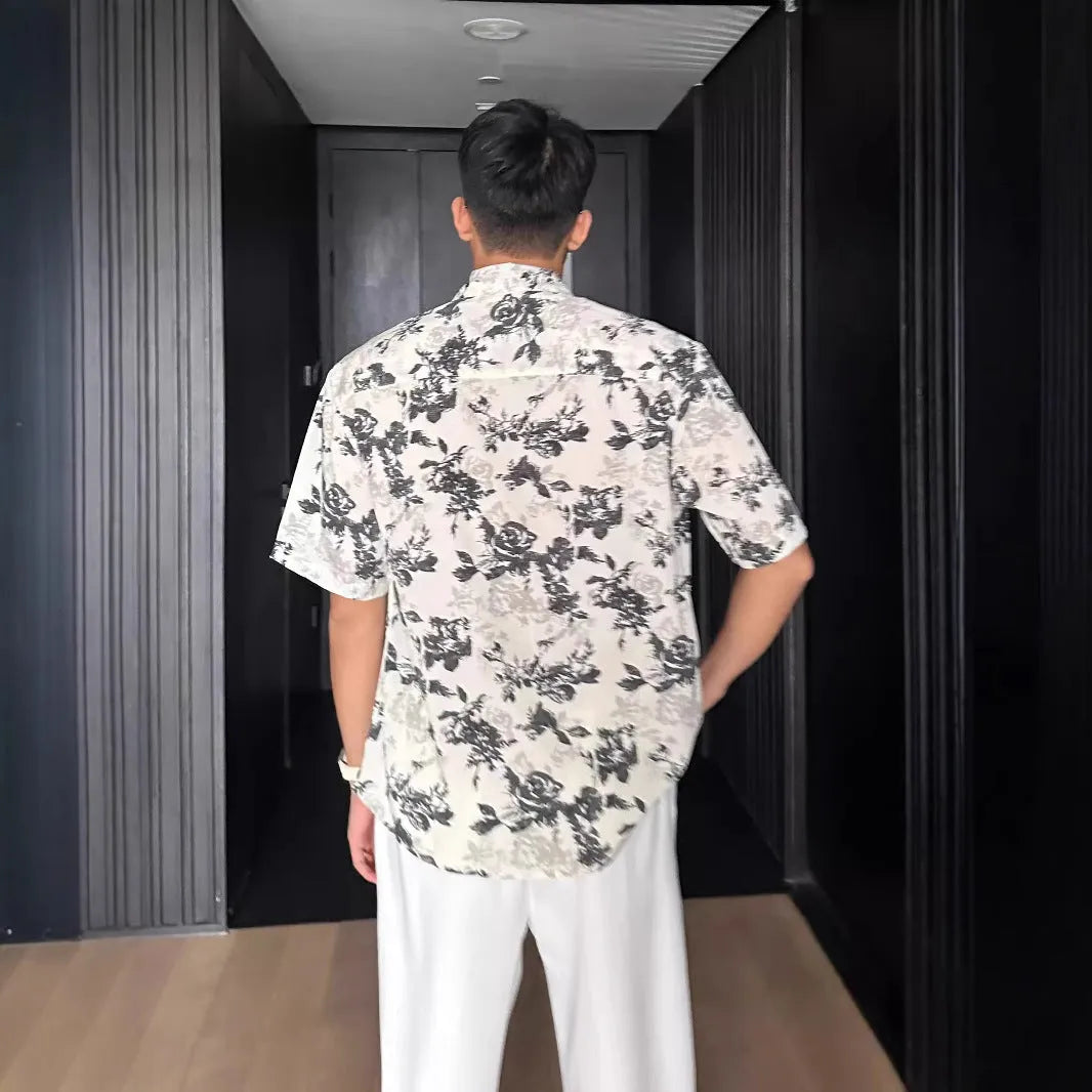 White loose-fit short sleeve casual shirt with a floral print and an open cardigan style front.