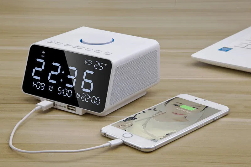 Black and white wireless Bluetooth alarm clock speaker with digital display, showing radio and call functions.