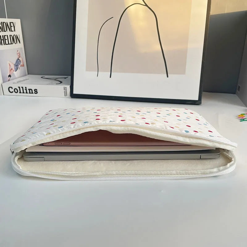 Women's polka dot polyester laptop bag shown in solid colour with size options for 11-inch to 15.6-inch laptops.