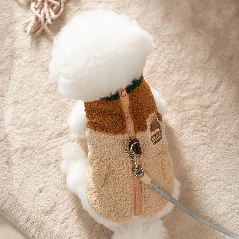 Colour-block pet fleece jacket with squirrel patch, leash ring, and pockets in green, brown, and beige on a small dog.