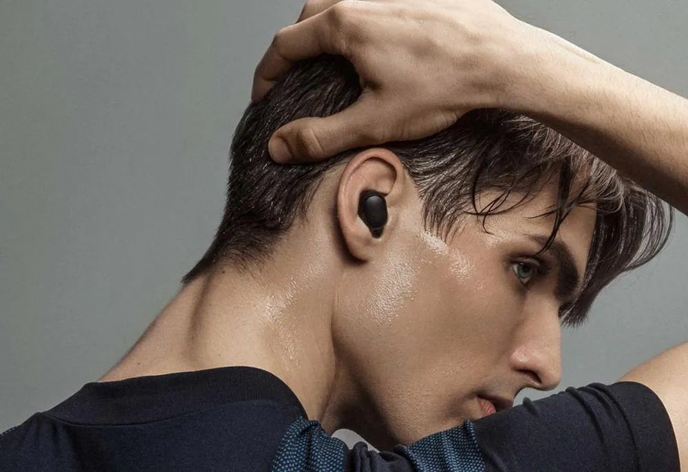 Redmi AirDots black true wireless Bluetooth headphones and charging case.