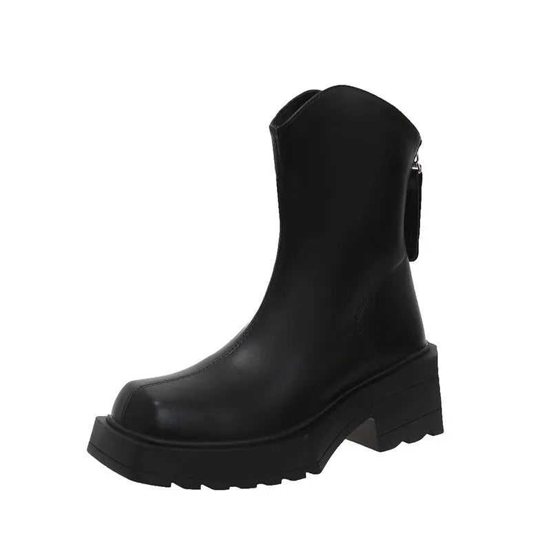 Women's black platform Martin ankle boots with a square toe and back zipper on a model.