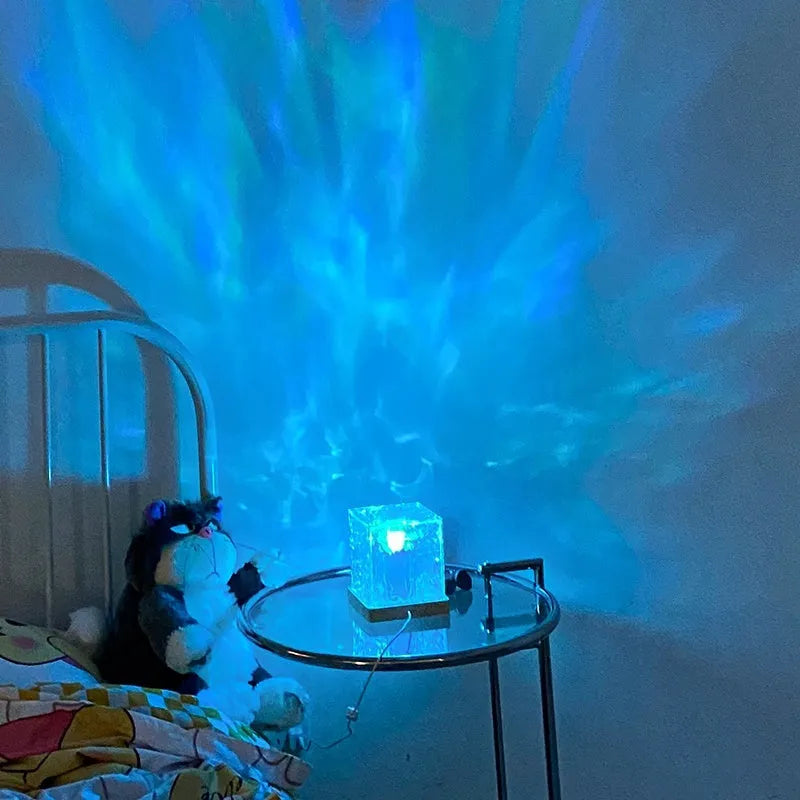 LED water ripple night light with rotating crystal projection and remote control on wooden surface
