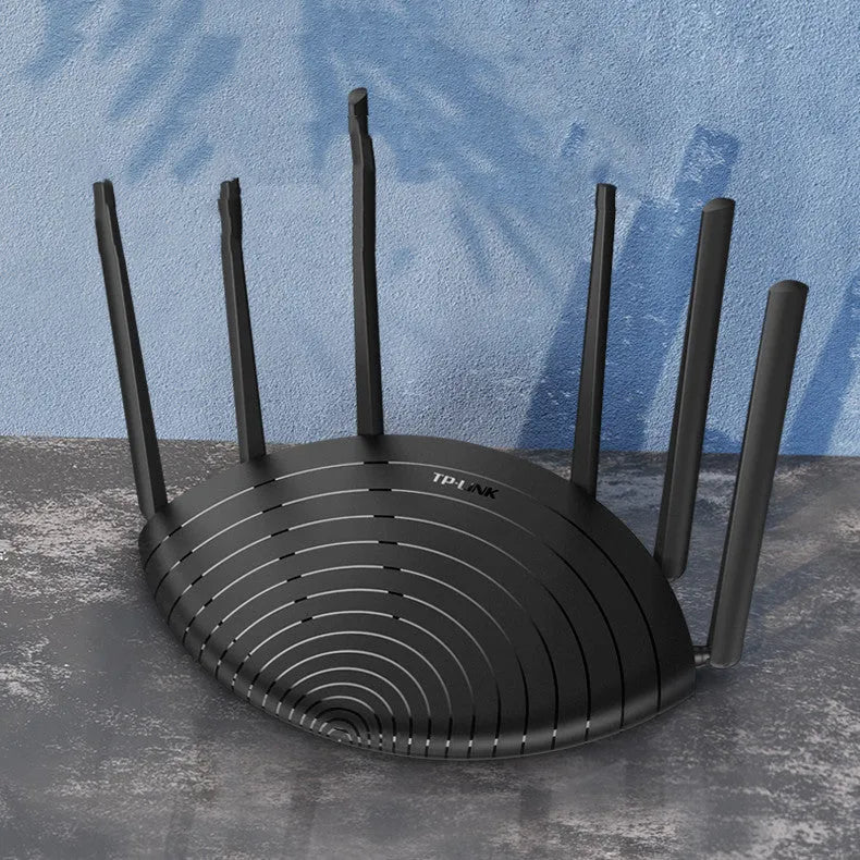 TP-Link TL-WDR7661 black AC1900 gigabit wireless router with fixed antennas on a desk.