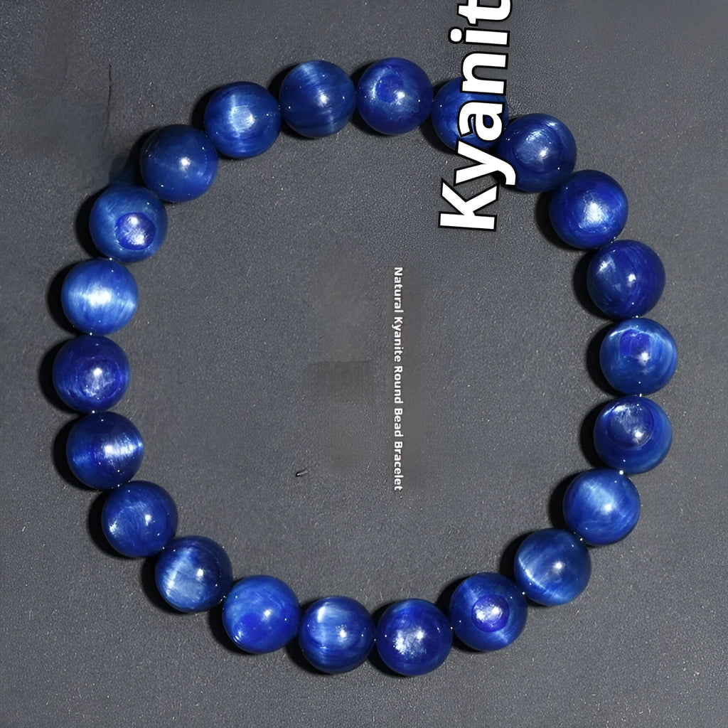 Blue crystal ball bracelet with geometric design and Ruyi motif on a white background.