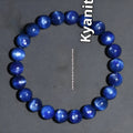 Blue crystal ball bracelet with geometric design and Ruyi motif on a white background.
