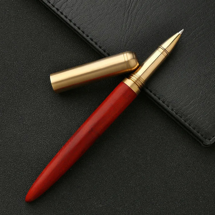 Brass and solid wood signature pen showing wood grain and metal components