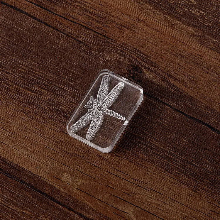 Transparent acrylic hand seal with silicone base showing Dragonfly and Fei Xue Fern colour pattern options