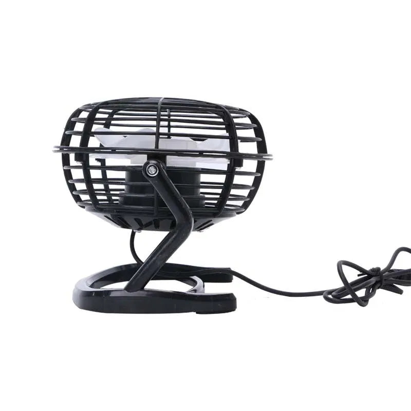 Black mini USB desk fan with adjustable angle on a wooden desk.