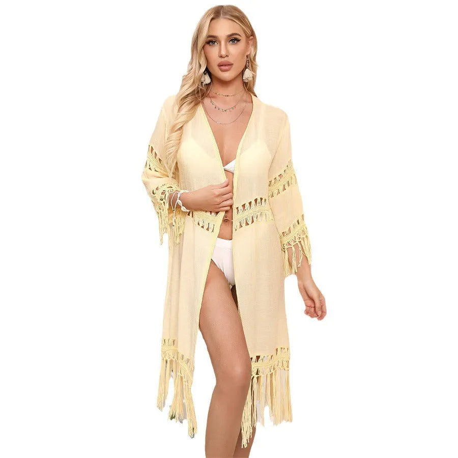 Yellow hand crocheted women's cardigan with tassel detail, a loose beach cover-up.