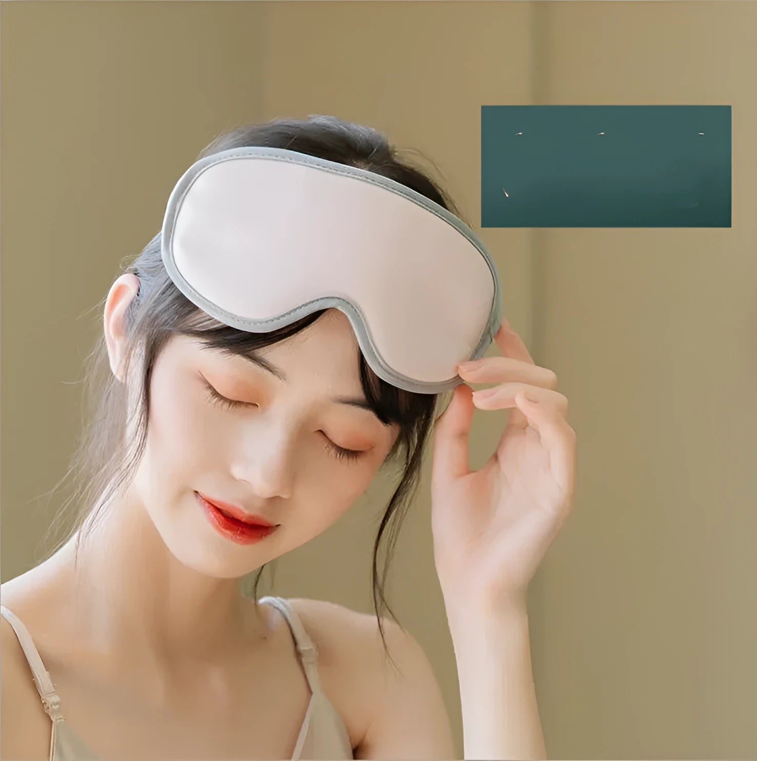 Pink and green portable eye massage goggles with USB cable on a grey background.