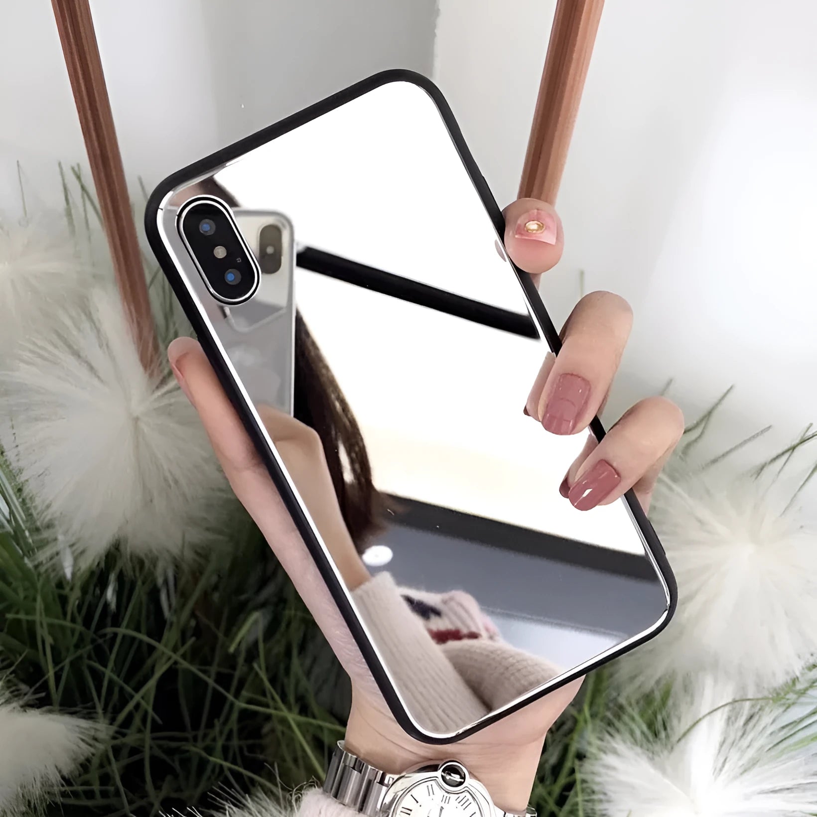 Black iPhone phone case with a built-in circular mirror on the back, shown next to an iPhone.