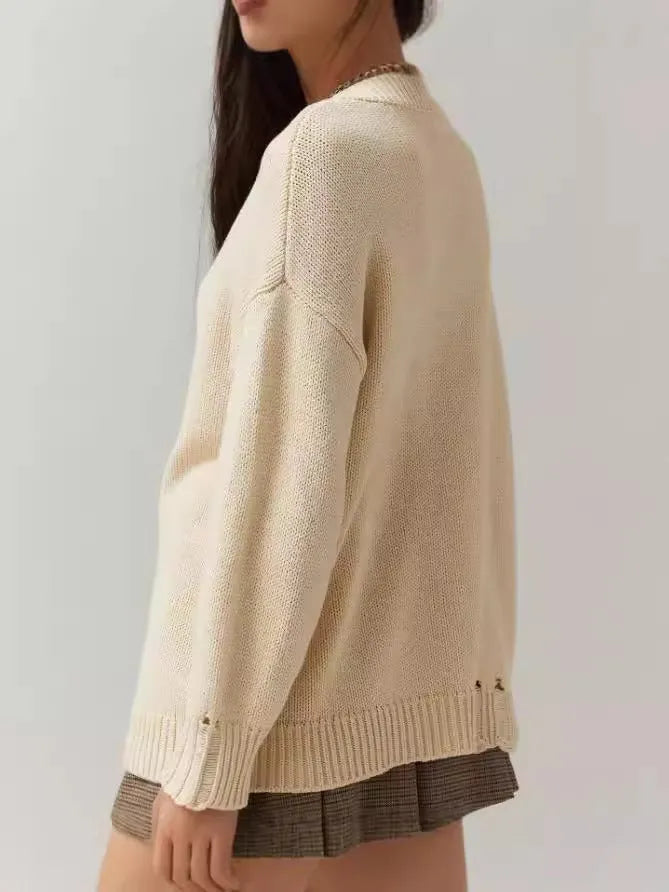 Women's milky white beige acrylic jacquard knit pullover sweater with round neck and long sleeves.