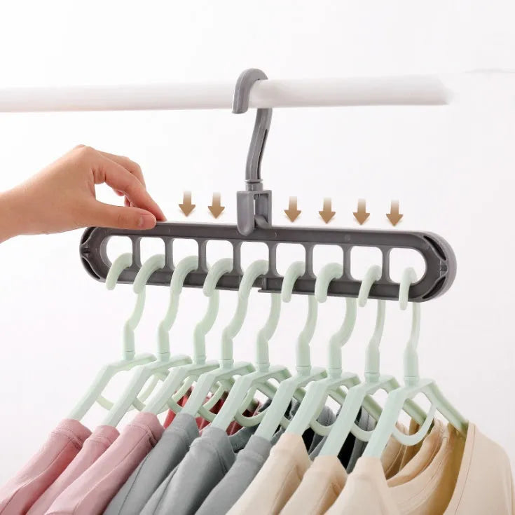 Pink plastic clothes hanger with a rotating hook on a white background.