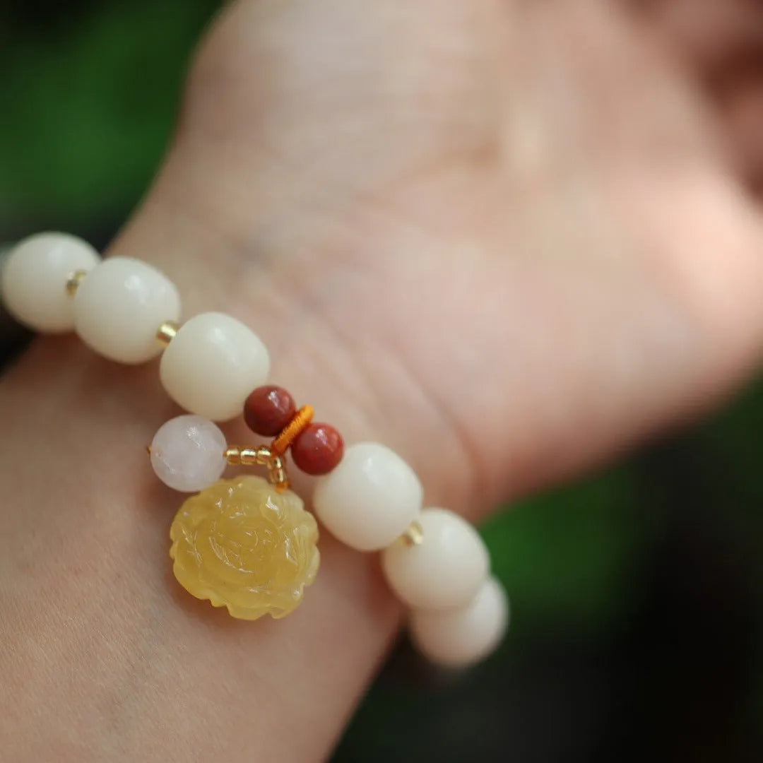 Women's handwoven bracelet with gradient White Jade beads and beeswax Lotus pendant on Bodhi root