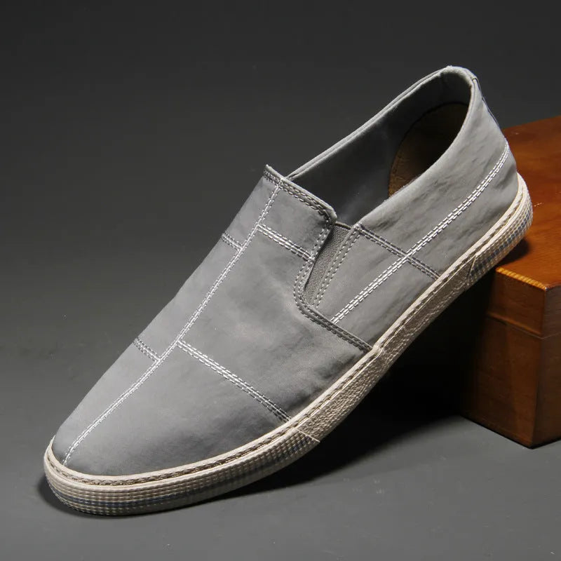 Men's low-top slip-on canvas shoes in various colours showing round toe and vulcanised rubber sole.