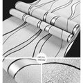 Close-up of light grey curve stripe 3D velvet wallpaper texture on a non-woven roll
