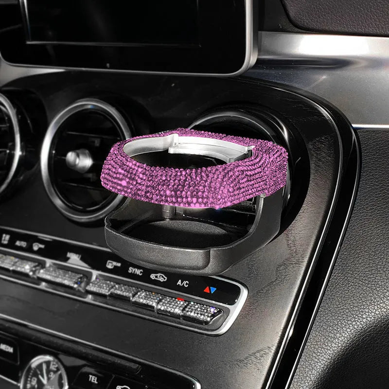 White diamond decorated car cup holder bracket mounted on a vehicle air vent.