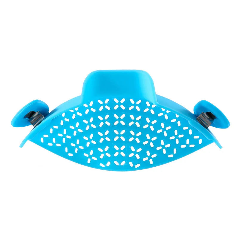 Green silicone pot side drain stopper kitchen gadget with stainless steel on wooden surface