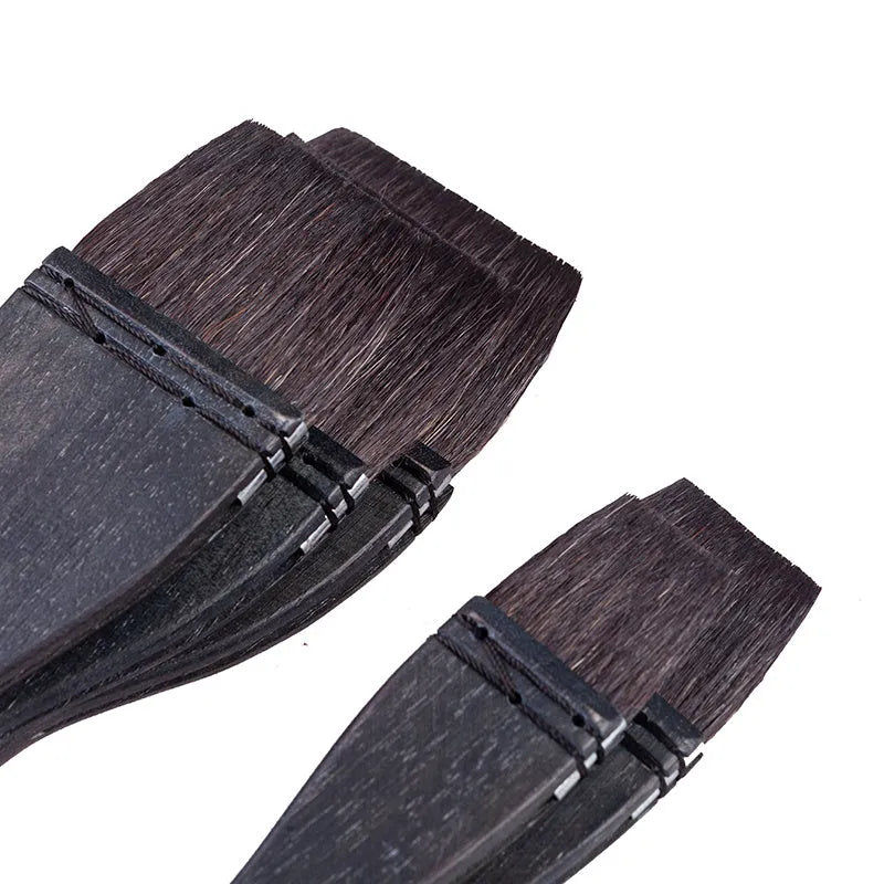 Set of five grey squirrel hair makeup brushes with wooden handles in different sizes from 30mm to 70mm wide.