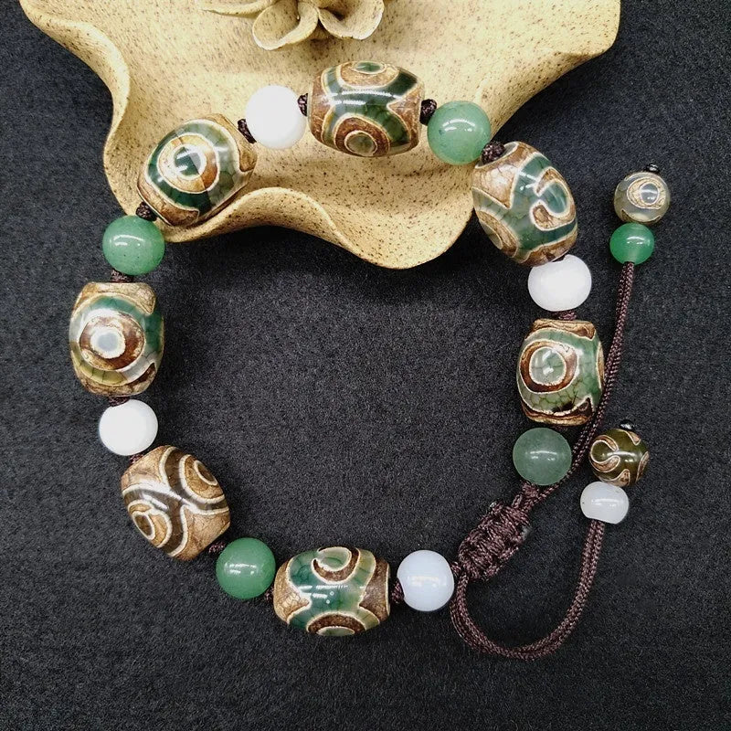 Green agate ethnic bracelet with a large three-eye bead and hand-woven band.