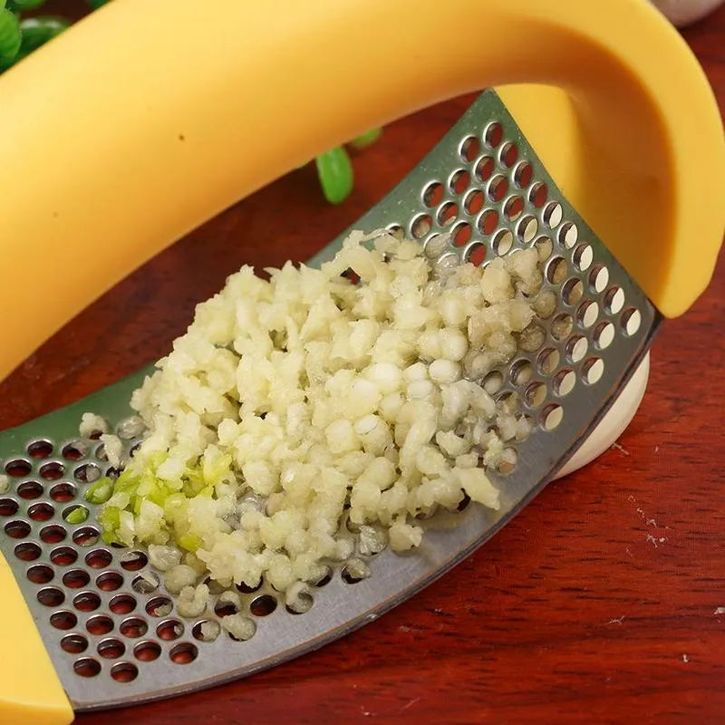 Stainless steel garlic press with ergonomic handle in available colours for kitchen use