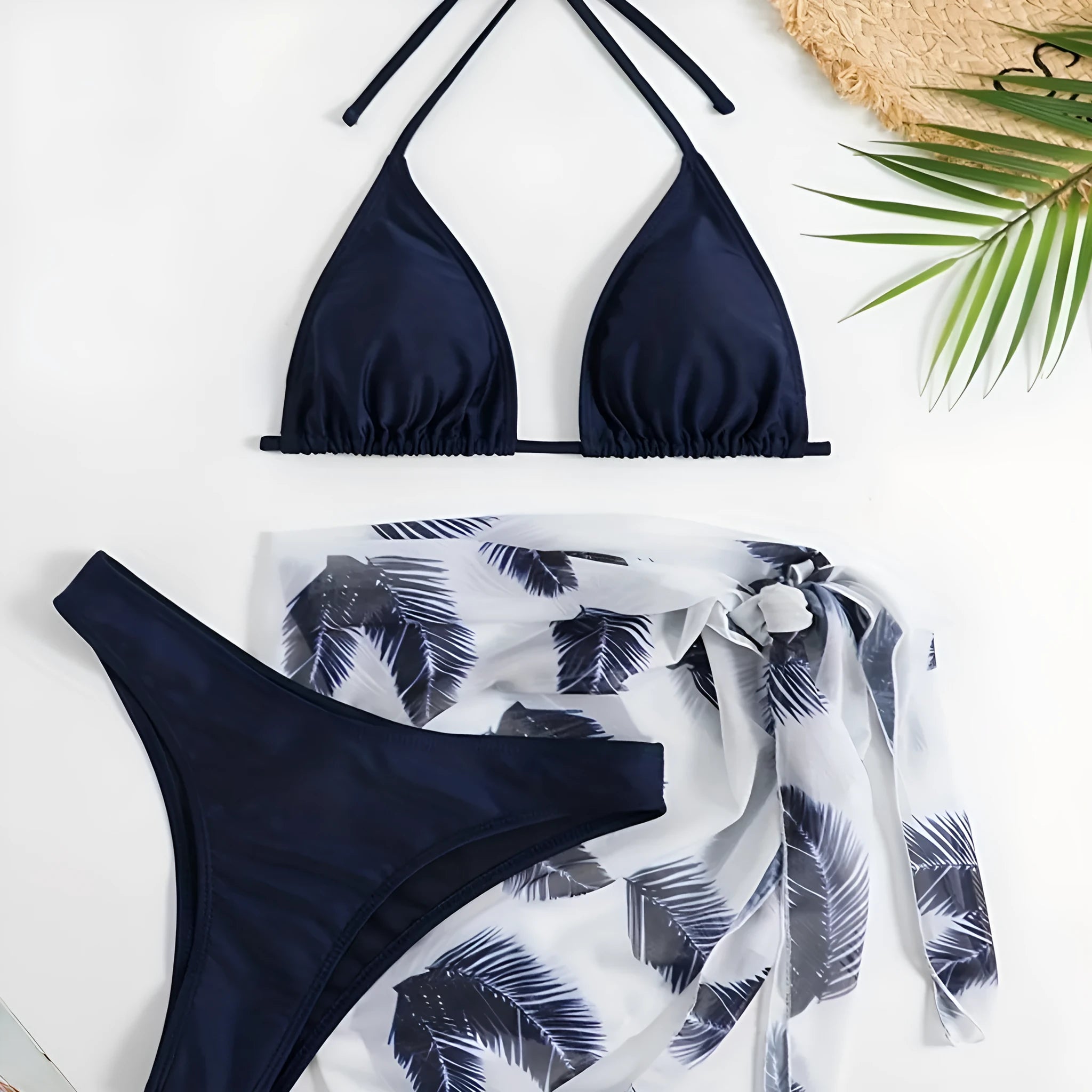 Orange three-piece swimsuit set showing bikini top, bottom, and a loose printed gauze skirt on a mannequin.