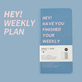 A5 weekly plan diary handbook open on a desk, showing weekly layout, with blue, brown, green, and purple cover options.